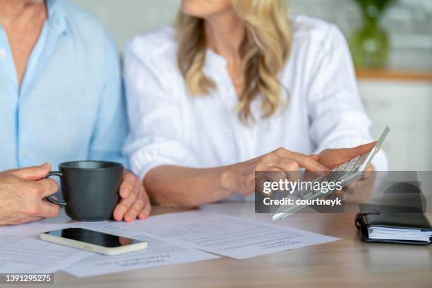 couple d’âge mûr travaillant sur les finances de leur maison. - emprunt immobilier photos et images de collection