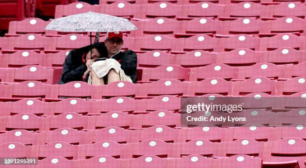 Fans sit in the rain during the Cincinnati Reds against the Cleveland Guardians at Great American Ball Park on April 13, 2022 in Cincinnati, Ohio.