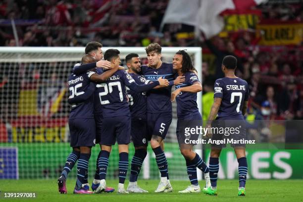 Joao Cancelo, Riyad Mahrez, John Stones and Nathan Ake of Manchester City celebrate with teammates after the UEFA Champions League Quarter Final Leg...