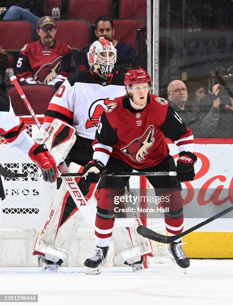 Nathan Smith of the Arizona Coyotes attempts to screen Nico Daws of the New Jersey Devils at Gila River Arena on April 12, 2022 in Glendale, Arizona....