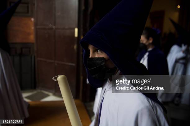 Penitent boy from the brotherhood of Rosario takes part in the Holy Wednesday procession on April 13, 2022 in Granada, Spain. With Easter week...