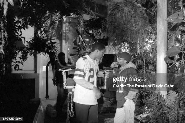 Filmmaker Spike Lee and jazz saxophonist, composer and bandleader Branford Marsalis on set at the Bronx Botanical Gardens as Lee directs Marsalis'...