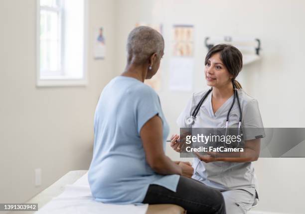 cancer patient having a check-up - mature adult with doctor stock pictures, royalty-free photos & images