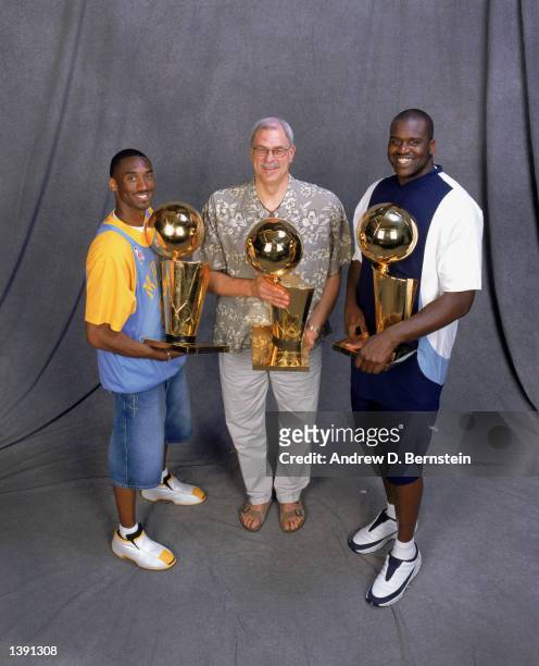 Guard Kobe Bryant, head coach Phil Jackson and center Shaquille O'Neal of the Los Angeles Lakers pose for a studio portrait with their three...