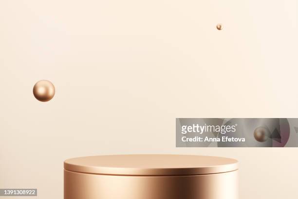 golden podium with three flying golden spheres on beige background. best backdrop for showing your products. copy space for your design - cilindro formas geométricas imagens e fotografias de stock