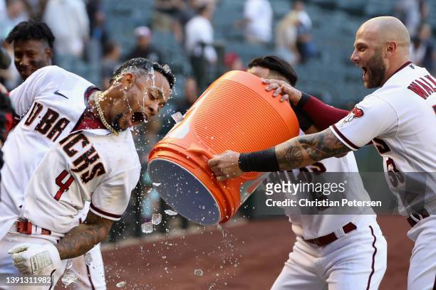 Ketel Marte of the Arizona Diamondbacks is dunked with gatorade by David Peralta and Christian Walker after a walk off sacrifice fly against the...