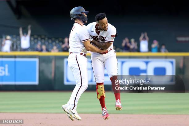 Ketel Marte of the Arizona Diamondbacks celebrates with Cooper Hummel a walk off sacrifice fly against the Houston Astros during the MLB game at...