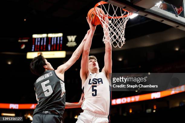 Kyle Filipowski of USA Team shoots against Mike Sharavjamts of World Team in the first quarter during the Nike Hoop Summit at Moda Center on April...