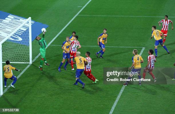 Simon Colosimo of the Heart watches as his shot on goal is saved by Adama Traore of Gold Coast United during the round 20 A-League match between the...