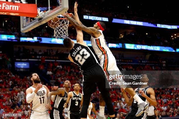 Brandon Ingram of the New Orleans Pelicans dunks the ball over Zach Collins of the San Antonio Spurs during the first quarter of the 2022 NBA Play-In...