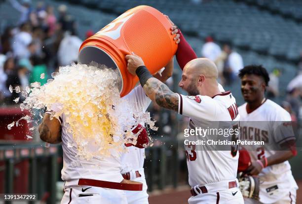 Ketel Marte of the Arizona Diamondbacks is dunked with gatorade by David Peralta and Christian Walker after a walk off sacrifice fly against the...