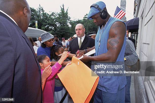 Center Shaquille O'Neal of the Los Angeles Lakers signs autographs outside the team's hotel the day after winning Game Four of the 2002 NBA Finals...