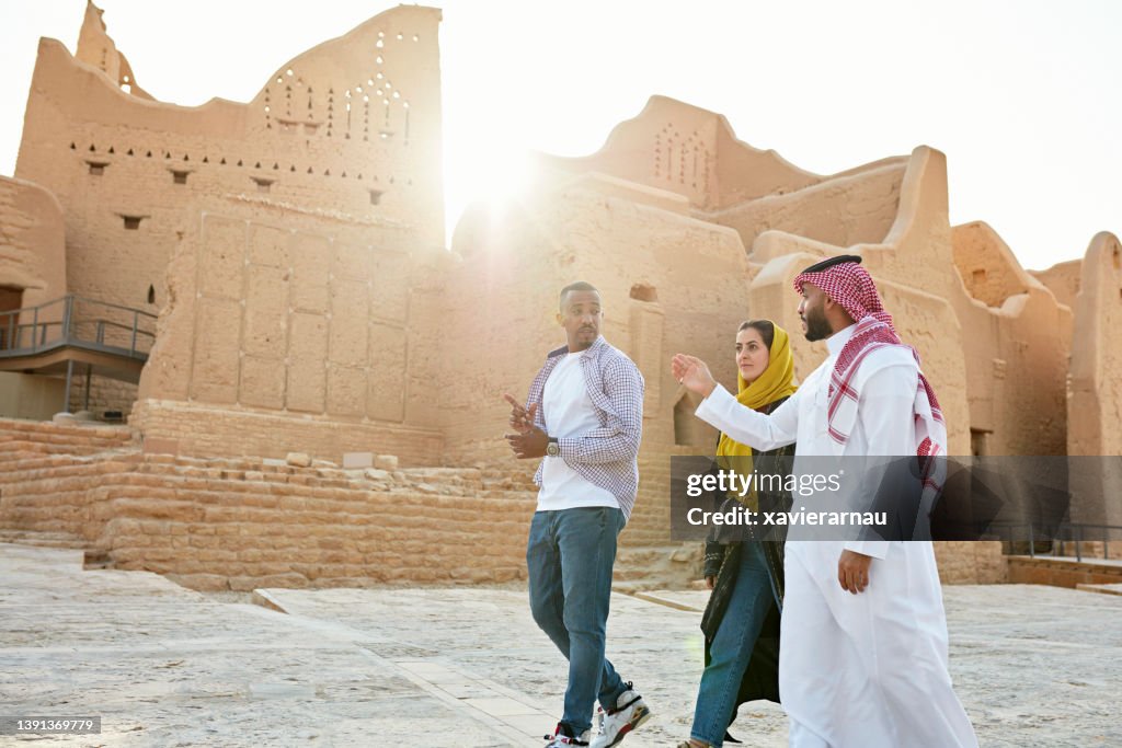 Guide pointing out features of Diriyah ruins near Riyadh