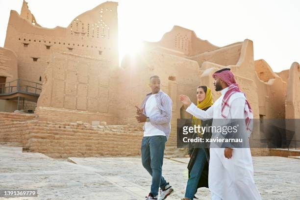 guide pointing out features of diriyah ruins near riyadh - arab group stockfoto's en -beelden