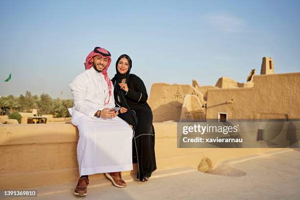 portrait of relaxed saudi couple at open air museum - saudi arabia national day stock pictures, royalty-free photos & images