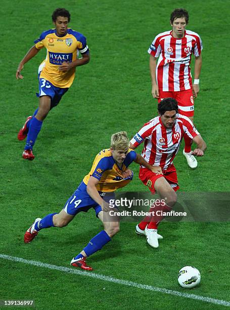 Ben Halloran of Gold Coast United is challenged by Wayne Srhoj of the Heart during the round 20 A-League match between the Melbourne Heart and Gold...