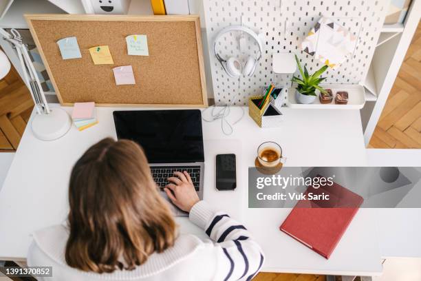 freelancer typing on laptop - online bulletin board stock pictures, royalty-free photos & images