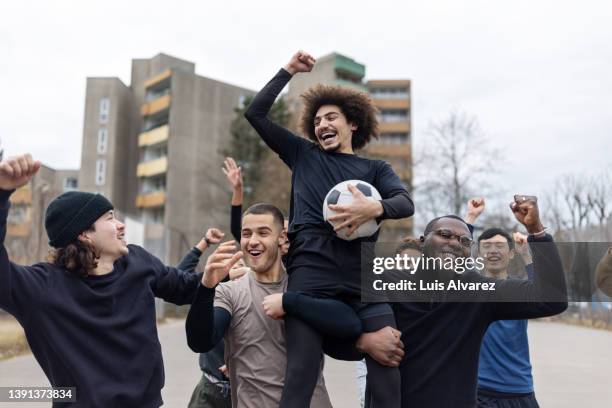 winning football team cheering on playing field - football team ストックフォトと画像