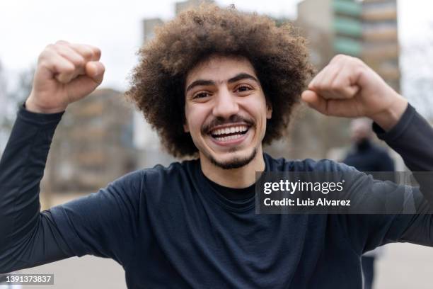 young soccer player cheering and celebrate victory - urban football pitch stock pictures, royalty-free photos & images