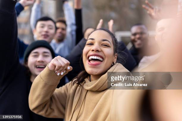 cheerful soccer players having fun taking a selfie outdoors - friends cheering stock pictures, royalty-free photos & images