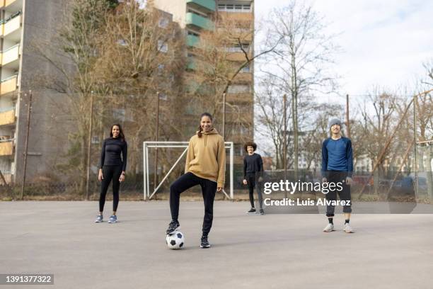 group of players at urban soccer court - urban football pitch stock pictures, royalty-free photos & images
