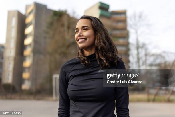 young hispanic woman standing at urban soccer court - court notice bildbanksfoton och bilder