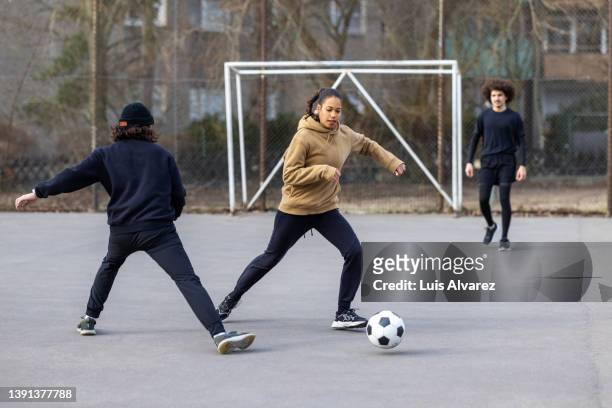 multi-ethnic soccer athletes playing match on street - game 27 23 stock pictures, royalty-free photos & images