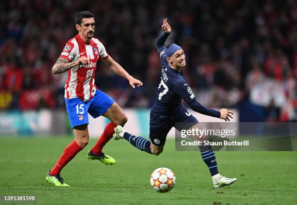 Phil Foden of Manchester City battles for possession with Stefan Savic of Atletico Madrid during the UEFA Champions League Quarter Final Leg Two...