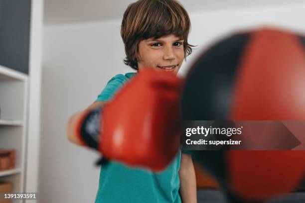 young boy practicing - punching ball stock pictures, royalty-free photos & images