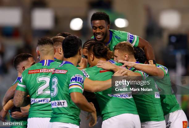 Tom Starling of the Raiders celebrates scoring a try with team mates during the round six NRL match between the Canberra Raiders and the North...