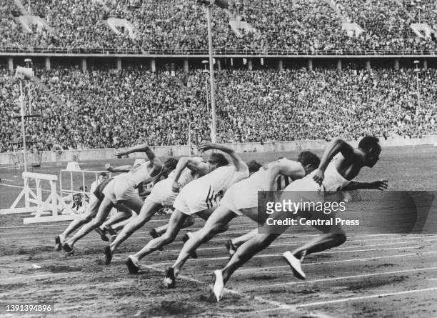 American athlete Jesse Owens and the rest of the field at the start of the final of the men's 100-metres event of the 1936 Summer Olympics, held in...