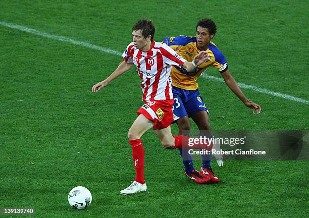 Craig Goodwin of the Heart is challenged by Mitch Cooper of Gold Coast United during the round 20 A-League match between the Melbourne Heart and Gold...