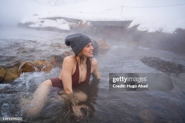 young woman in a hot spring bath in iceland. - river bathing stock pictures, royalty-free photos & images