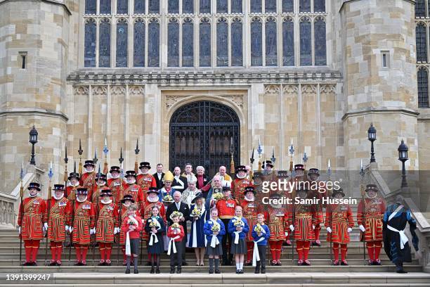 Camilla, Duchess of Cornwall and Prince Charles, Prince of Wales hold nosegays as they attend the Royal Maundy Service at St George's Chapel on April...