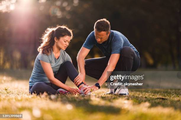 let me help you with that injured leg! - sport accident stock pictures, royalty-free photos & images