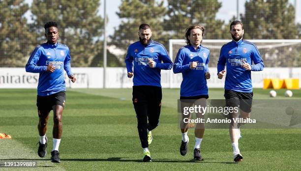 Vinicius Jr., Karim Benzema, Luka Modric and Nacho Fernandez players of Real Madrid are training at Valdebebas training ground on April 14, 2022 in...