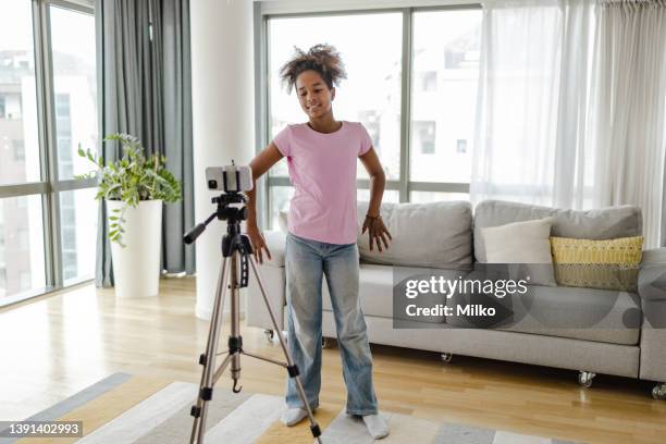 teenage girl filming herself dancing at home for social media - alpha female stock pictures, royalty-free photos & images
