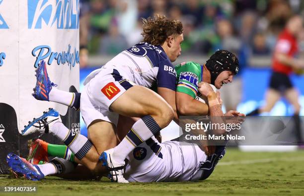 Brad Schneider of the Raiders is held up over the line during the round six NRL match between the Canberra Raiders and the North Queensland Cowboys...