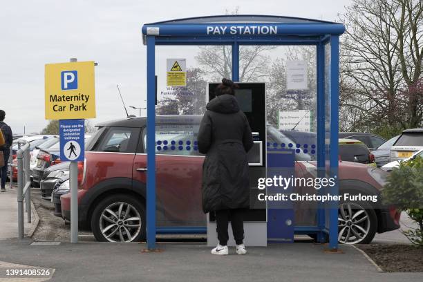 People pay for parking at Wythenshawe Hospita on April 14, 2022 in Manchester, England. Free parking in hospital car parks for NHS staff was...