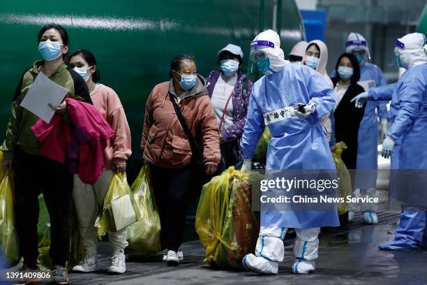 Patients who have recovered from COVID-19 leave a makeshift hospital converted from the National Exhibition and Convention Center on April 14, 2022...