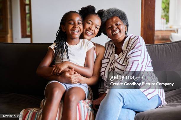 woman and her senior mom and young daughter laughing while sitting at home - grandma daughter stock pictures, royalty-free photos & images