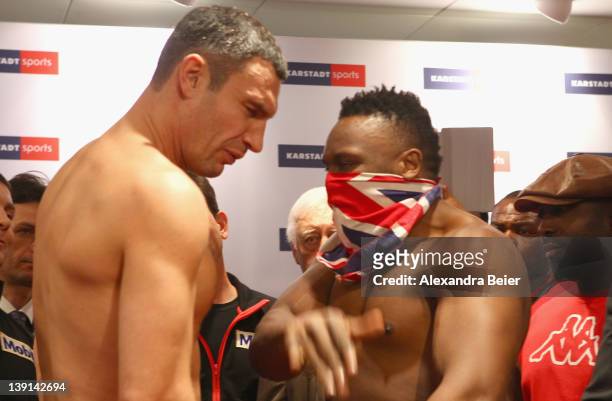 Heavyweight boxer Dereck Chisora of the UK slaps in the face of Vitali Klitschko of Ukraine during the weigh in for their upcoming WBC heavyweight...