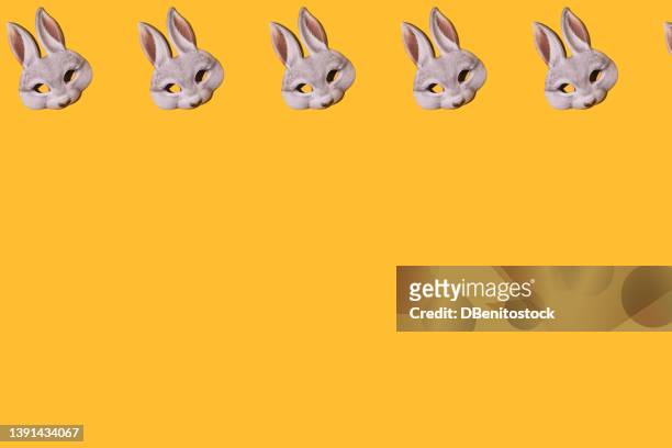 hare rabbit masks pattern with hard shadow. on top, on yellow background. disguise, masquerade, carnival, easter and fun concept. - easter bunny mask fotografías e imágenes de stock