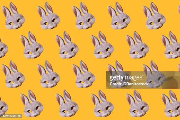 hare rabbit masks pattern with hard shadow on yellow background. disguise, masquerade, carnival, easter and fun concept. - easter bunny mask imagens e fotografias de stock