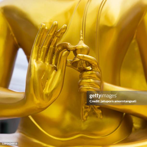 hand of golden buddha - idol stock-fotos und bilder