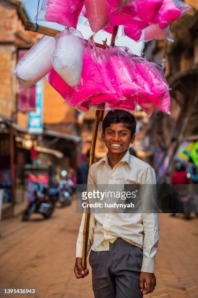 young nepali boy selling a cotton candy in bhaktapur, nepal - cotton candy stock pictures, royalty-free photos & images
