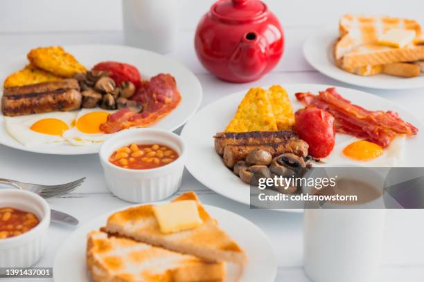 full english fried breakfast on white wooden surface - full english breakfast stock pictures, royalty-free photos & images