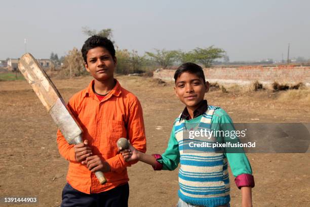 village boy playing cricket together - cricket player portrait stock pictures, royalty-free photos & images