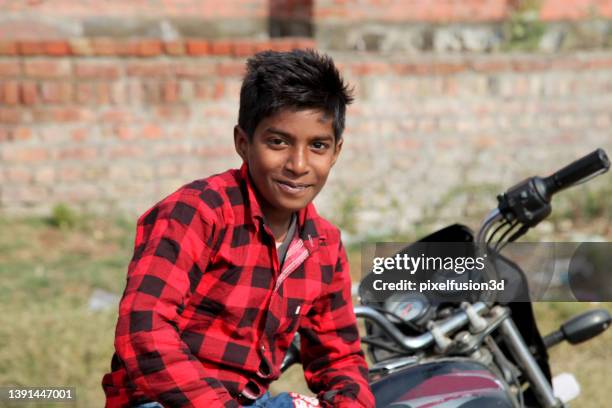 young boy sitting portrait near motorbike - 13 year old cute boys stock pictures, royalty-free photos & images