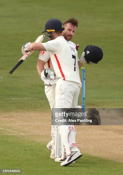 Steven Croft of Lancashire ceelebrates making 100 with team mate Phil Salt during the LV= Insurance County Championship match between Kent and...